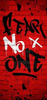 Red brick wall with graffiti text "Fear No One."