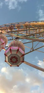 Ferris wheel with gondolas against blue sky.