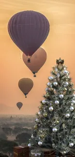 Hot air balloons float at sunset near a decorated Christmas tree.