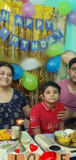 Family celebrating birthday with balloons and festive decor.