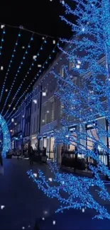 Blue Christmas lights adorn a city street at night.