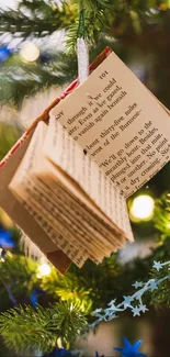 Christmas tree with book ornaments and festive lights.