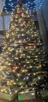 Illuminated book tree with festive lights and cozy interior ambiance.