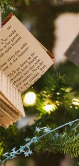 Christmas tree with book ornament and lights.