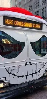 A city bus adorned with festive skull artwork and Santa hat.