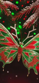 Festive butterfly ornament on a Christmas tree with red and green colors.