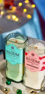 Bloom gin bottles and candles with festive decor on a tray.