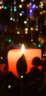 Red candle with twinkling lights and stars, creating a cozy festive atmosphere.