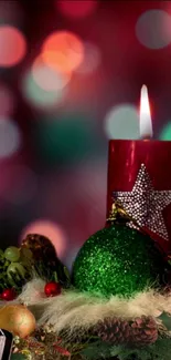 Red candle and Christmas ornaments with bokeh lights.