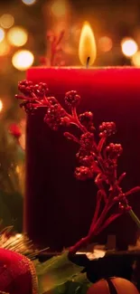 Festive red candle with decorative berries and warm glowing lights.