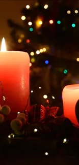Red candles glowing with holiday lights in the background.