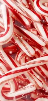 Red and white candy cane wallpaper with festive snow.