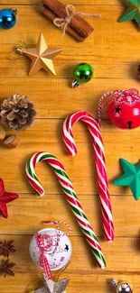 Festive candy cane wallpaper with ornaments on a wooden background.