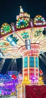 Colorful swing carousel at night carnival with bright lights.