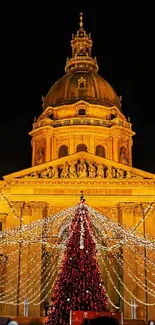 Illuminated cathedral with festive Christmas market lights.