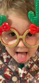 Child wearing festive glasses and making a funny face.