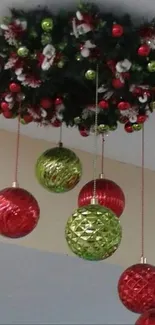 Festive ceiling with red and green Christmas ornaments creating holiday cheer.