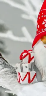 Festive Christmas gnome with gifts on snowy branch wallpaper.