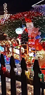 Santa and reindeer in vibrant Christmas lights display.