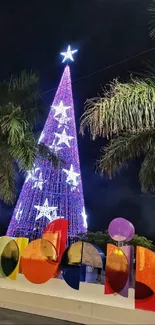 Festive illuminated Christmas tree with decorations at night.