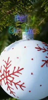 Festive Christmas ornament with snowflakes on a green tree.