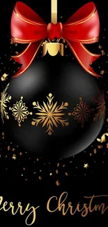 Christmas black ornament with red bow and gold snowflakes.