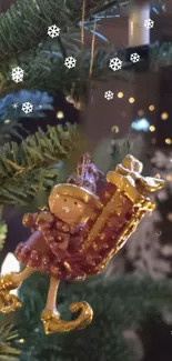 Festive ornament hanging on a Christmas tree with snowflakes and lights.