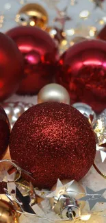 Festive red and gold Christmas ornaments with lights.