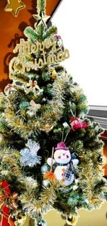 Festive Christmas tree with decorations and snowman on a mobile wallpaper background.