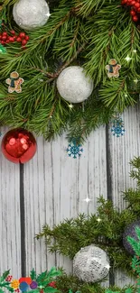 Festive Christmas wallpaper with ornaments and pine branches.