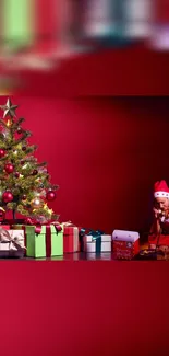 Festive Christmas tree and gifts on red backdrop.