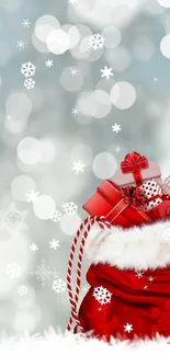 Festive Christmas wallpaper with Santa's gift bag against snowy bokeh background.