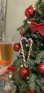 Christmas tree with red ornaments and champagne glass.