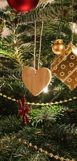 Close-up of a Christmas tree with golden ornaments and green branches.