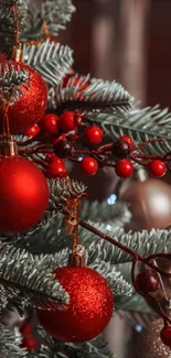 Christmas tree decorated with red ornaments and green branches.