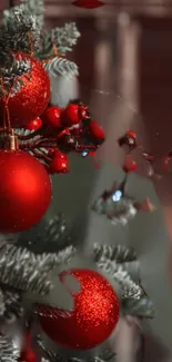 Close-up of a Christmas tree with red ornaments and festive details.