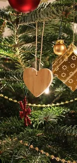 Christmas tree with gold ornaments and a wooden heart.