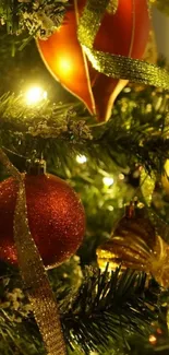 Festive Christmas tree with red ornaments and golden ribbons.