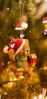 Teddy bear Christmas ornament on pine branches.