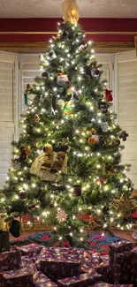 Christmas tree with gifts underneath, green with ornaments.