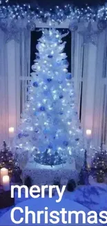 Festive Christmas tree with blue lights and candles in cozy setting.