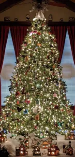 Decorated Christmas tree with lights and village houses under warm lighting.