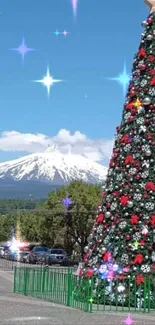 Festive Christmas tree with snowy mountain and blue sky.