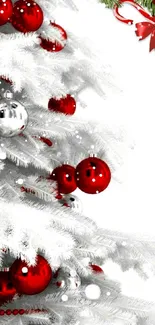 Festive Christmas tree with red ornaments on a snowy white background.