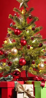 Festive Christmas tree with gifts on a red background.