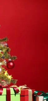 Festive Christmas tree with gifts on red background.