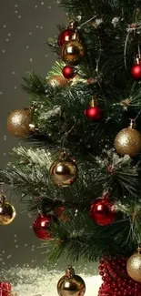 Festive Christmas tree with gold and red ornaments.