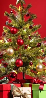 Christmas tree with gifts and ornaments on red background.