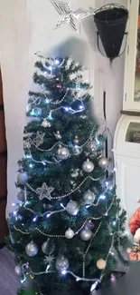 Festive Christmas tree with ornaments and Santa figurine.