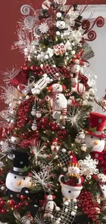 A festive Christmas tree with snowmen and red ornaments.